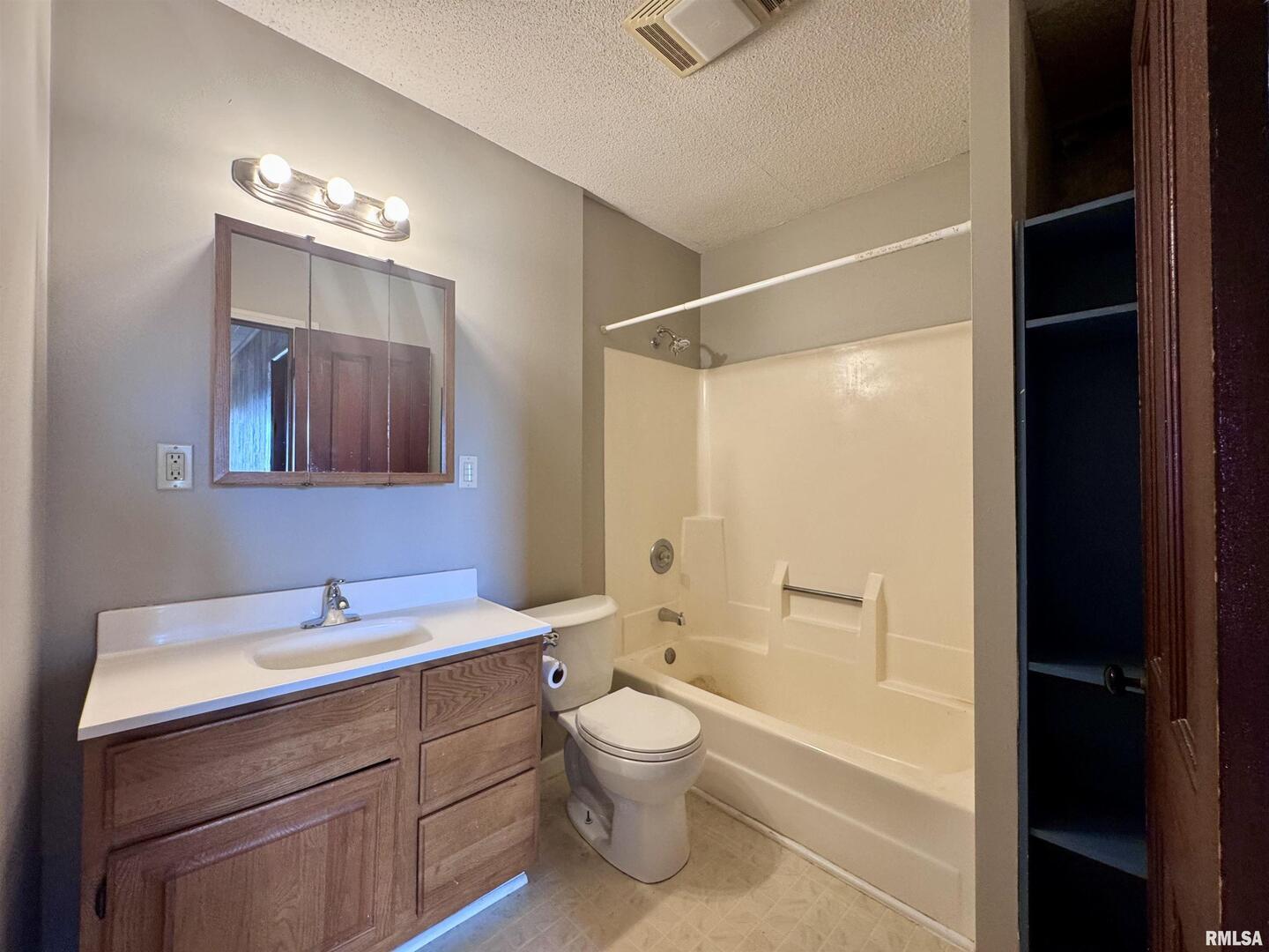 916 7th Street Fulton, IL 61252 - Photo 23 of 32 a bathroom with a toilet a sink and a large mirror