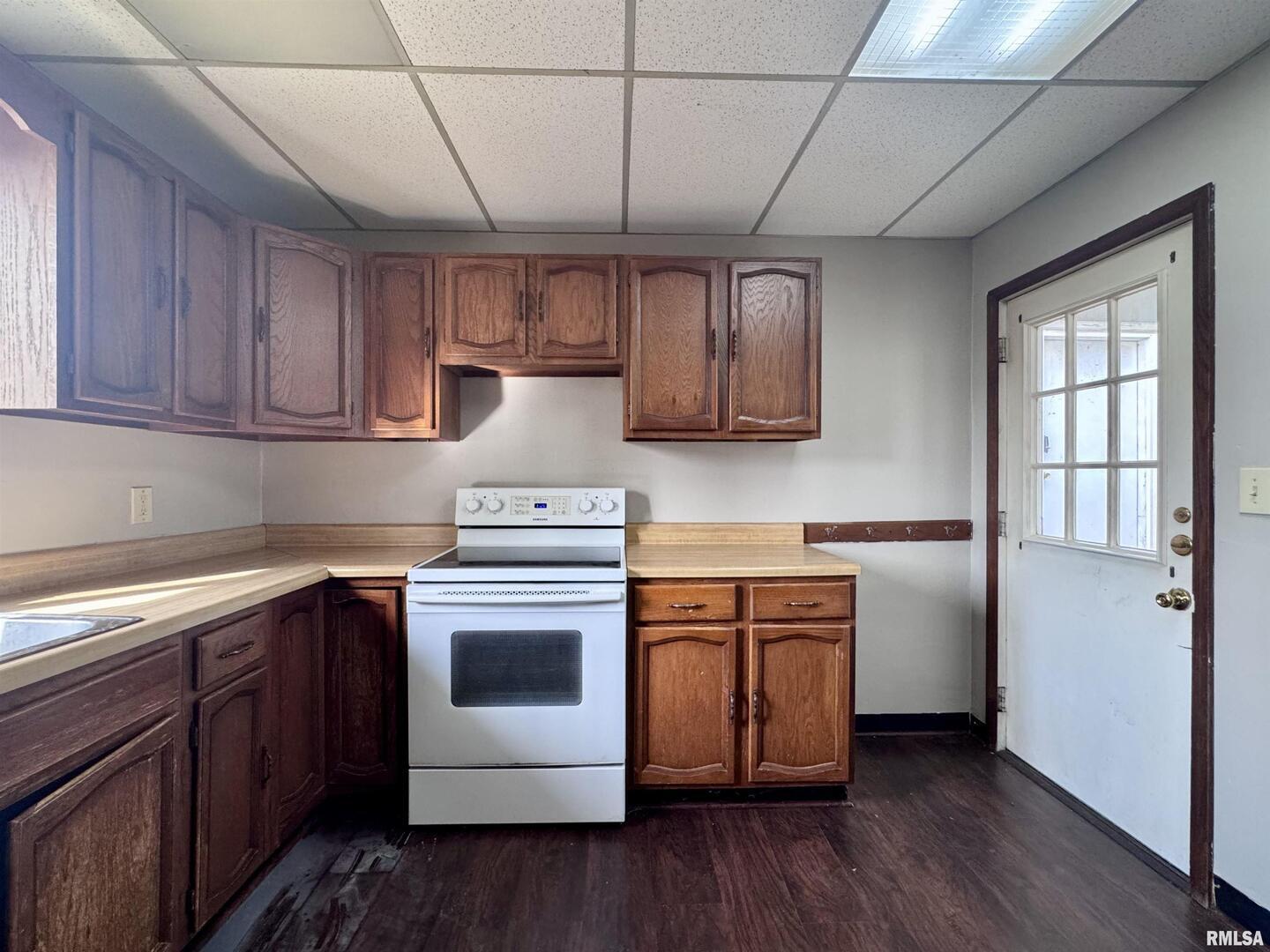 916 7th Street Fulton, IL 61252 - Photo 4 of 32 a kitchen with stainless steel appliances granite countertop a stove a sink dishwasher and a refrigerator with wooden cabinets