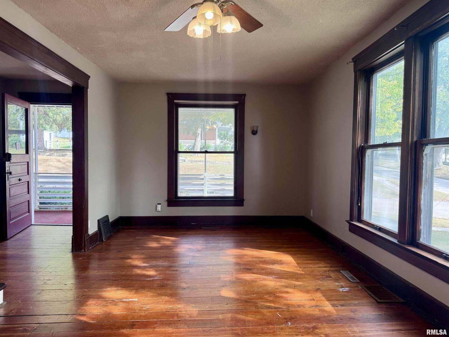 916 7th Street Fulton, IL 61252 - Photo 6 of 32 an empty room with wooden floor and windows
