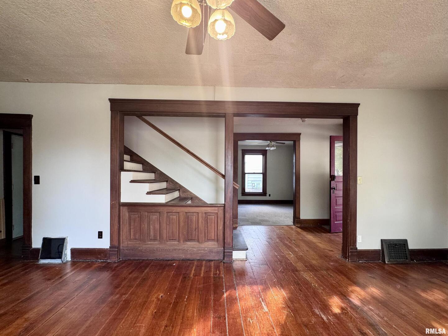 916 7th Street Fulton, IL 61252 - Photo 7 of 32 a view of a hallway with wooden floor and stairs