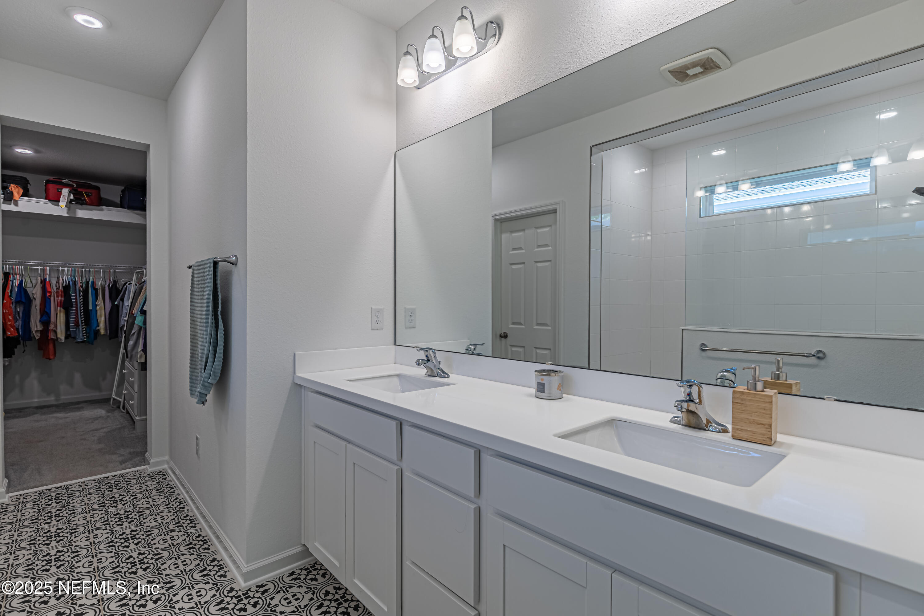 383 Windswept Way Street St. Augustine, FL 32092 - Photo 25 of 34 a bathroom with a sink a shower and a mirror