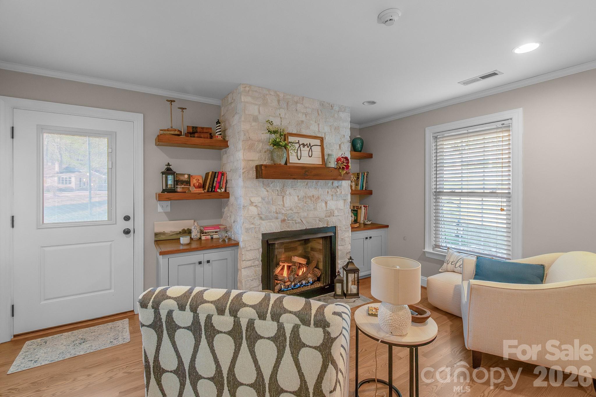 572 Acorn Acres Road Norwood, NC 28128 - Photo 2 of 39 a living room with furniture and a fireplace