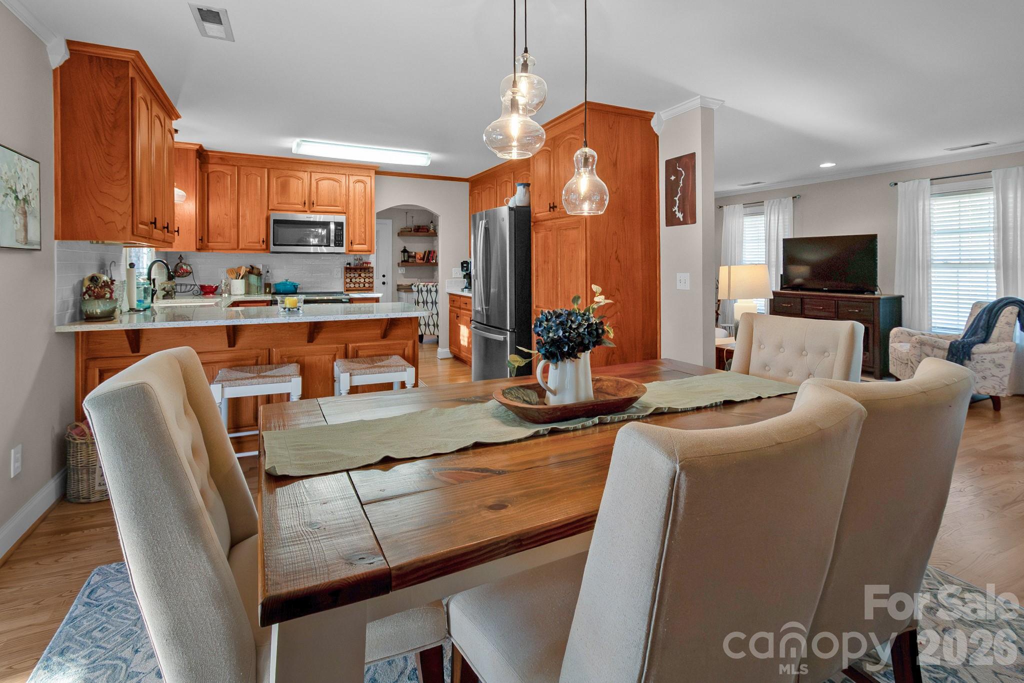 572 Acorn Acres Road Norwood, NC 28128 - Photo 22 of 39 a living room with furniture a flat screen tv and kitchen view