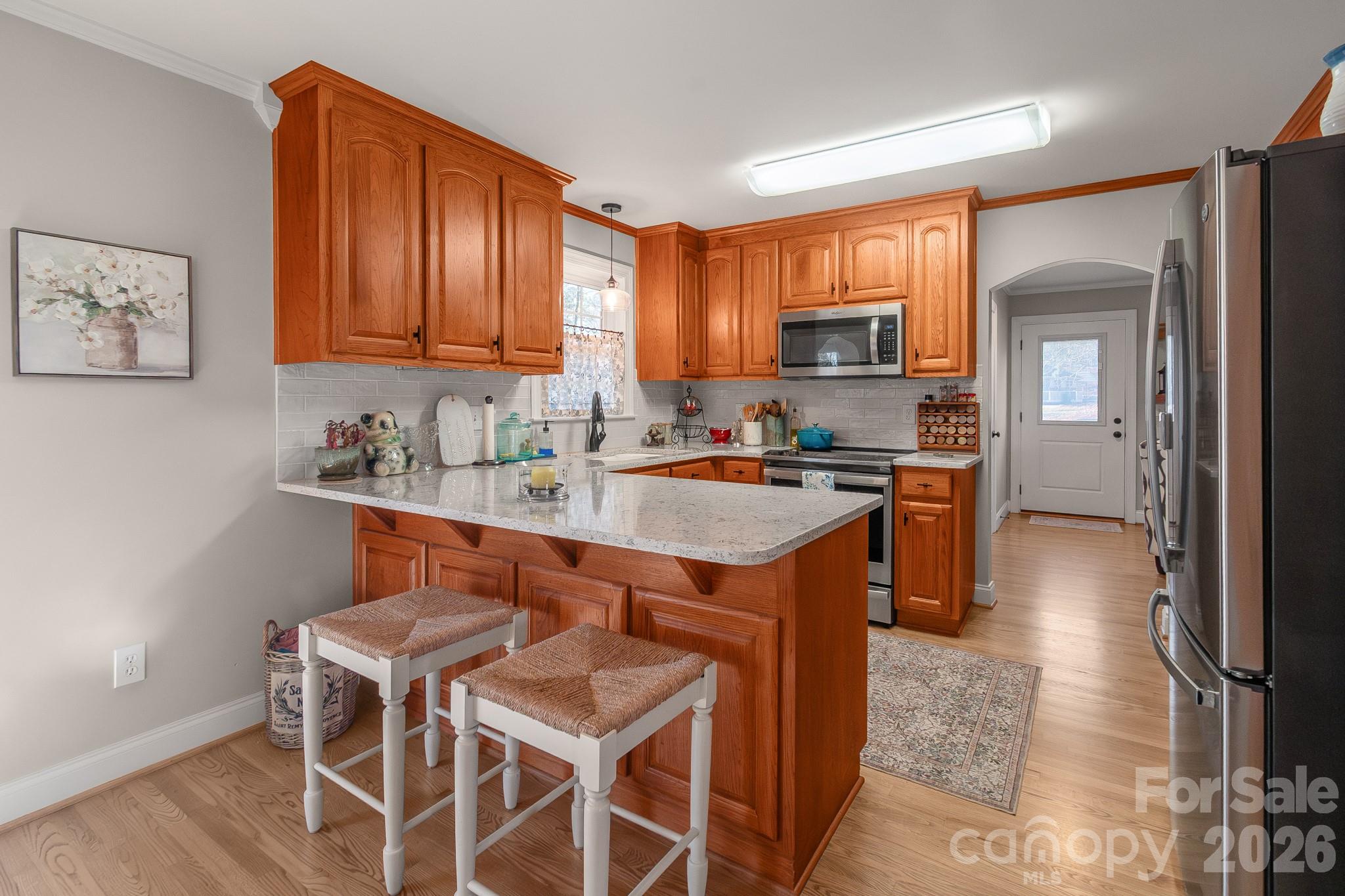 572 Acorn Acres Road Norwood, NC 28128 - Photo 23 of 39 a kitchen with granite countertop wooden cabinets and stainless steel appliances