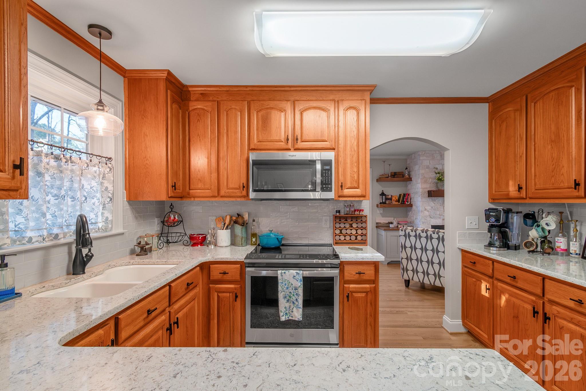 572 Acorn Acres Road Norwood, NC 28128 - Photo 24 of 39 a kitchen with stainless steel appliances granite countertop a sink stove and refrigerator