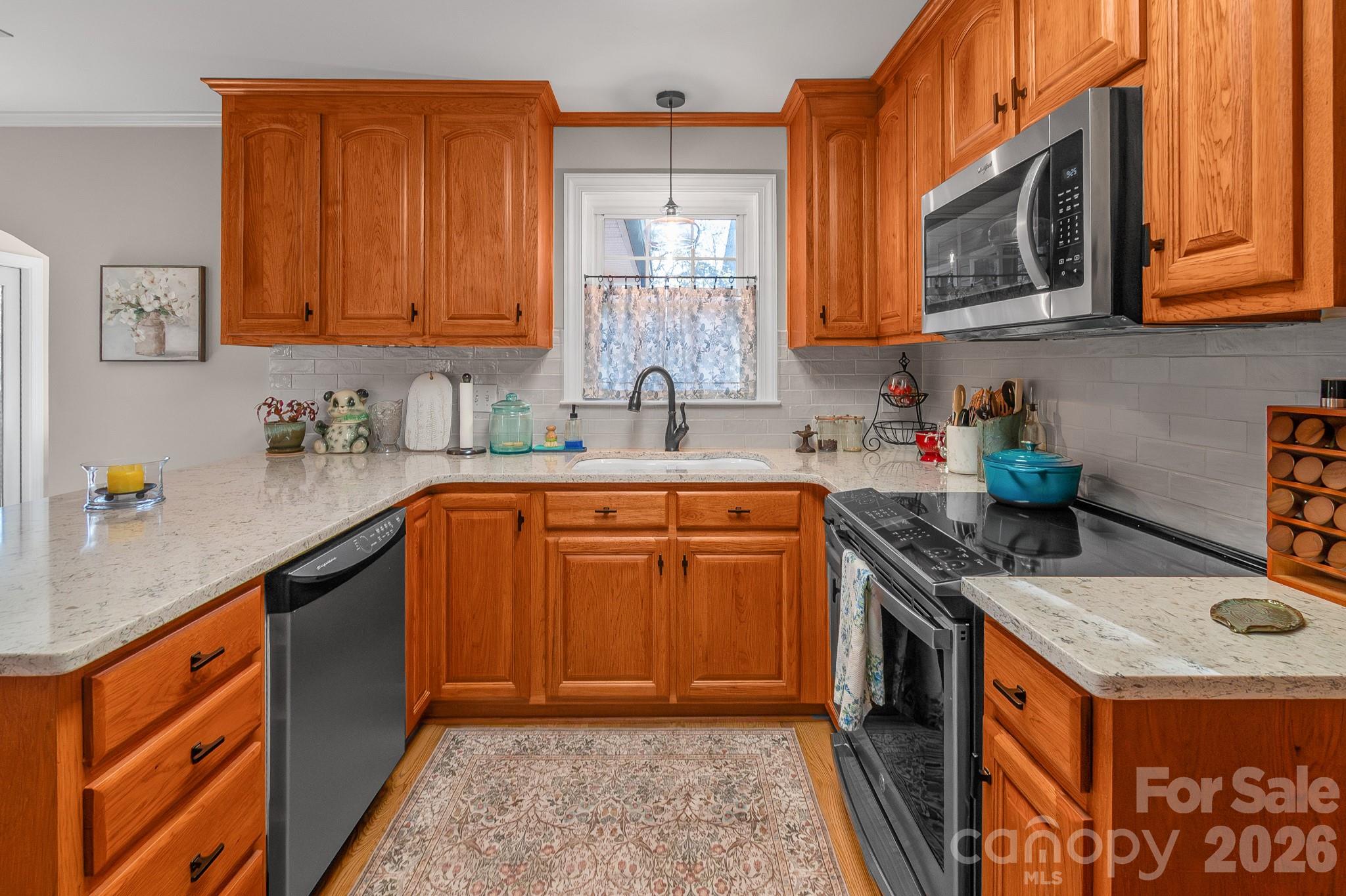 572 Acorn Acres Road Norwood, NC 28128 - Photo 25 of 39 a kitchen with stainless steel appliances granite countertop a sink stove and cabinets