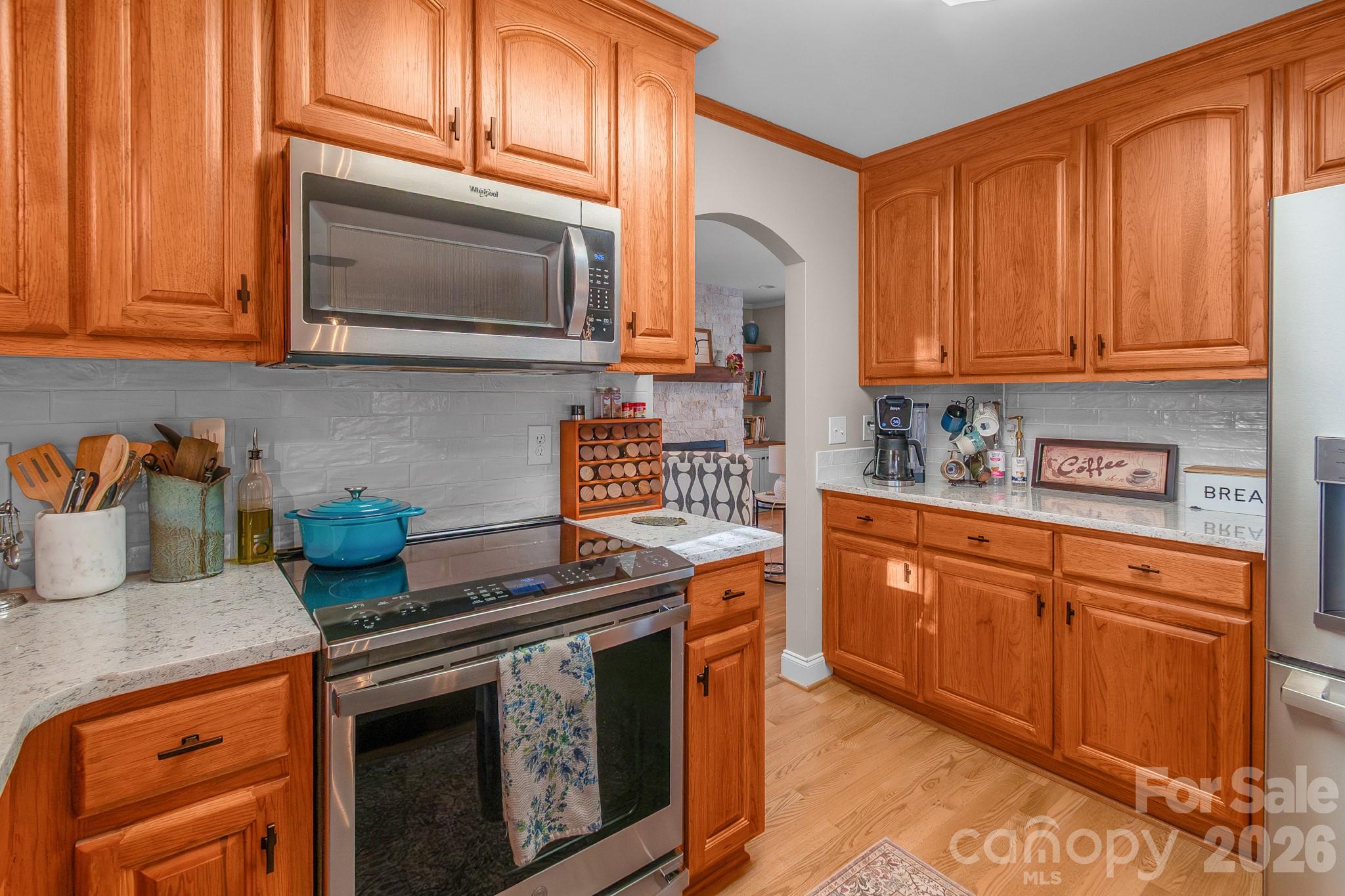 572 Acorn Acres Road Norwood, NC 28128 - Photo 28 of 39 a kitchen with stainless steel appliances granite countertop a stove a sink and a microwave