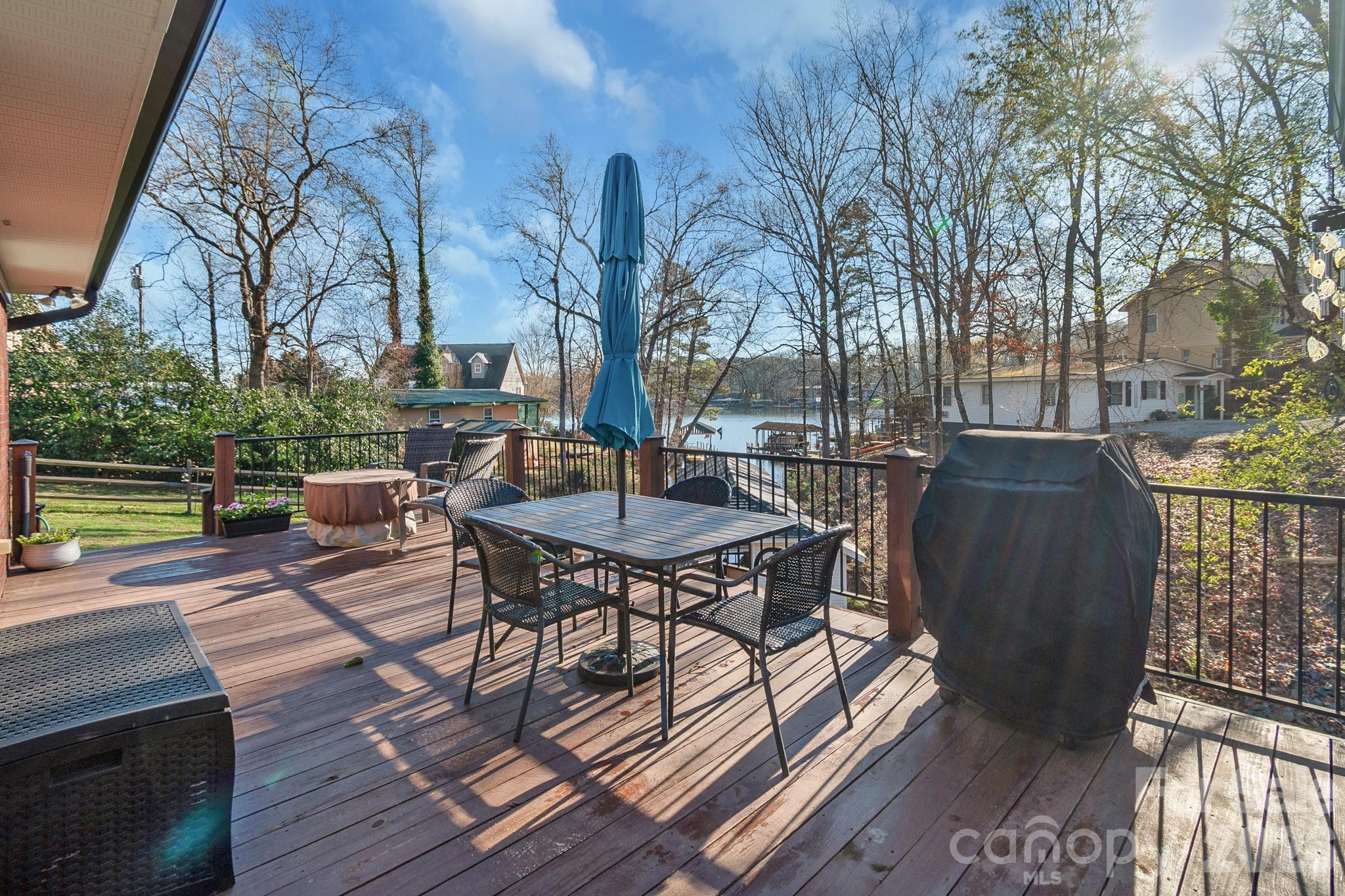 572 Acorn Acres Road Norwood, NC 28128 - Photo 29 of 39 a view of a patio with table and chairs and wooden floor