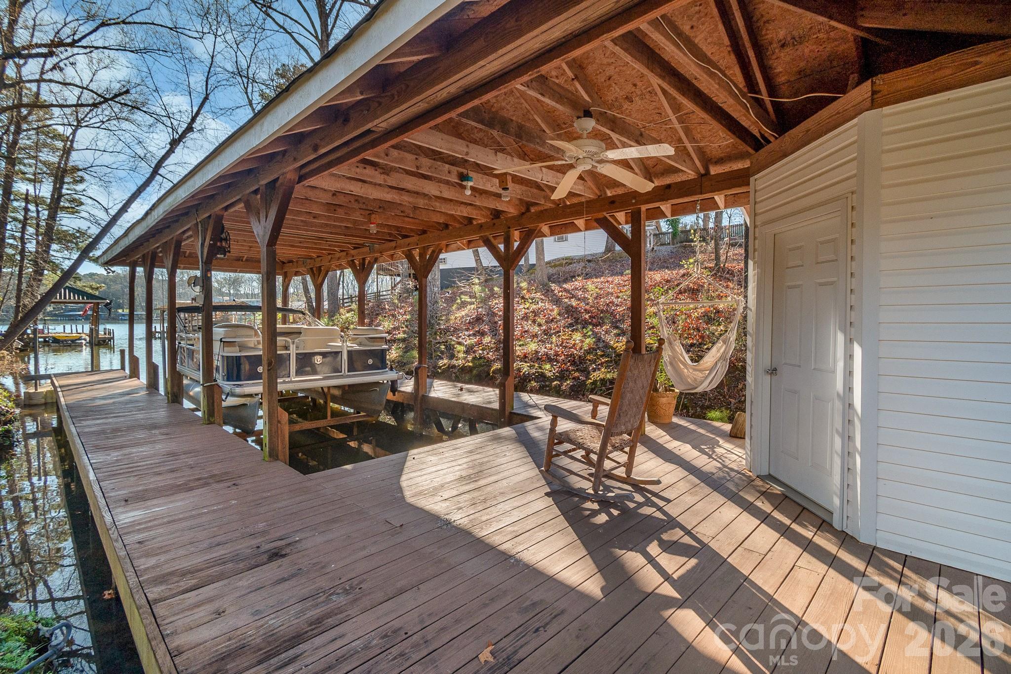 572 Acorn Acres Road Norwood, NC 28128 - Photo 32 of 39 a view of a balcony with chairs and wooden floor