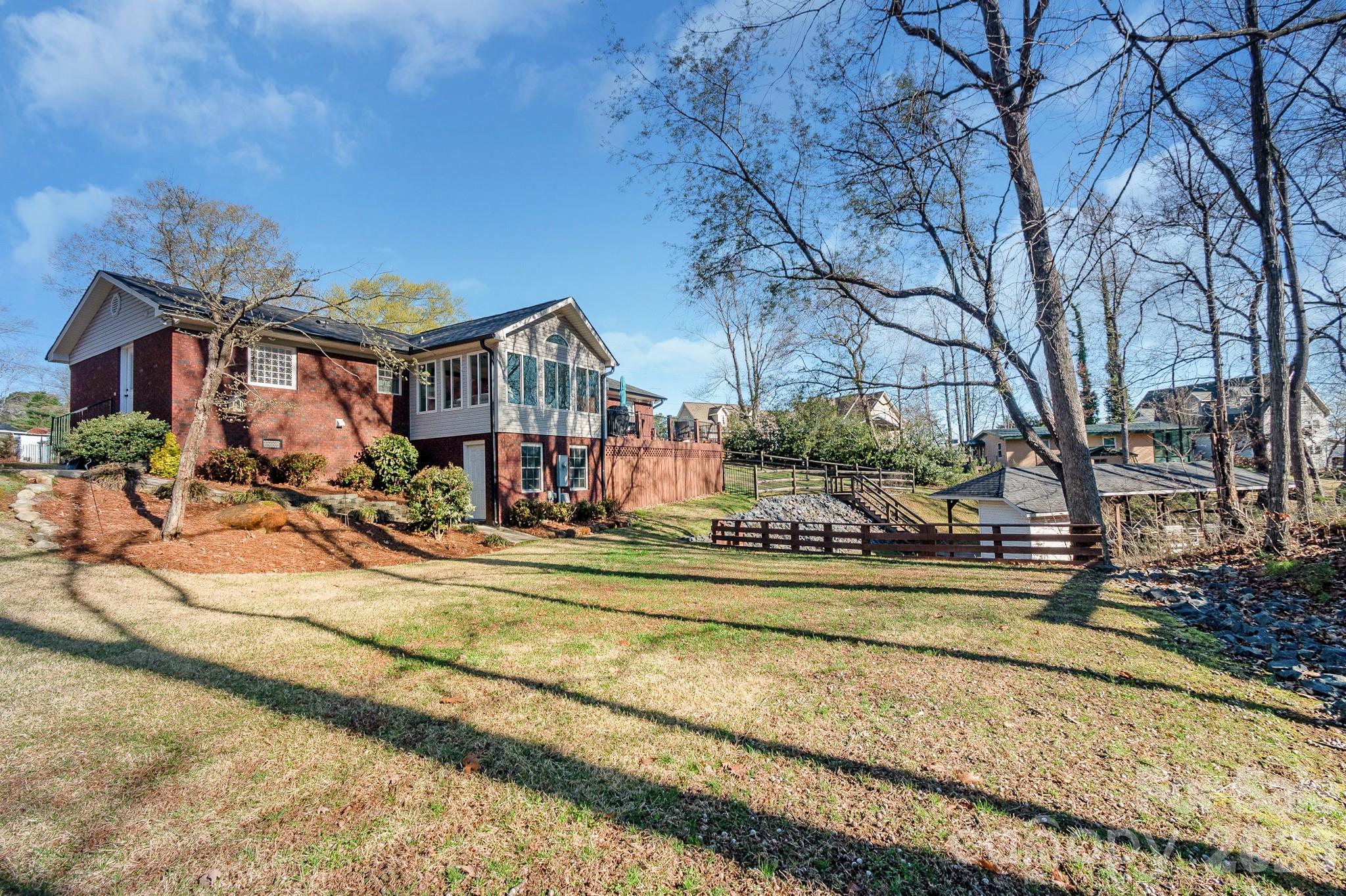 572 Acorn Acres Road Norwood, NC 28128 - Photo 37 of 39 a view of a house with a small yard and large trees