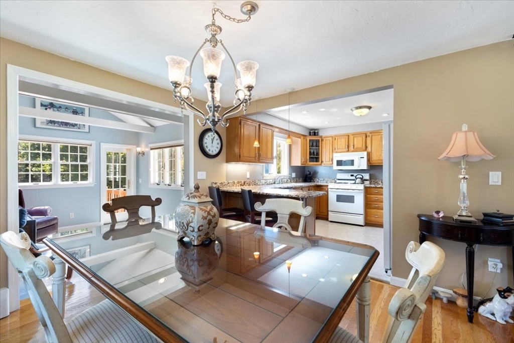 30 South Cross Road Haverhill, MA 01835 - Photo 11 of 42 a view of a dining room and livingroom with furniture wooden floor a chandelier