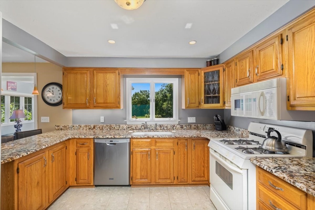 30 South Cross Road Haverhill, MA 01835 - Photo 13 of 42 a kitchen with granite countertop a sink stainless steel appliances and window