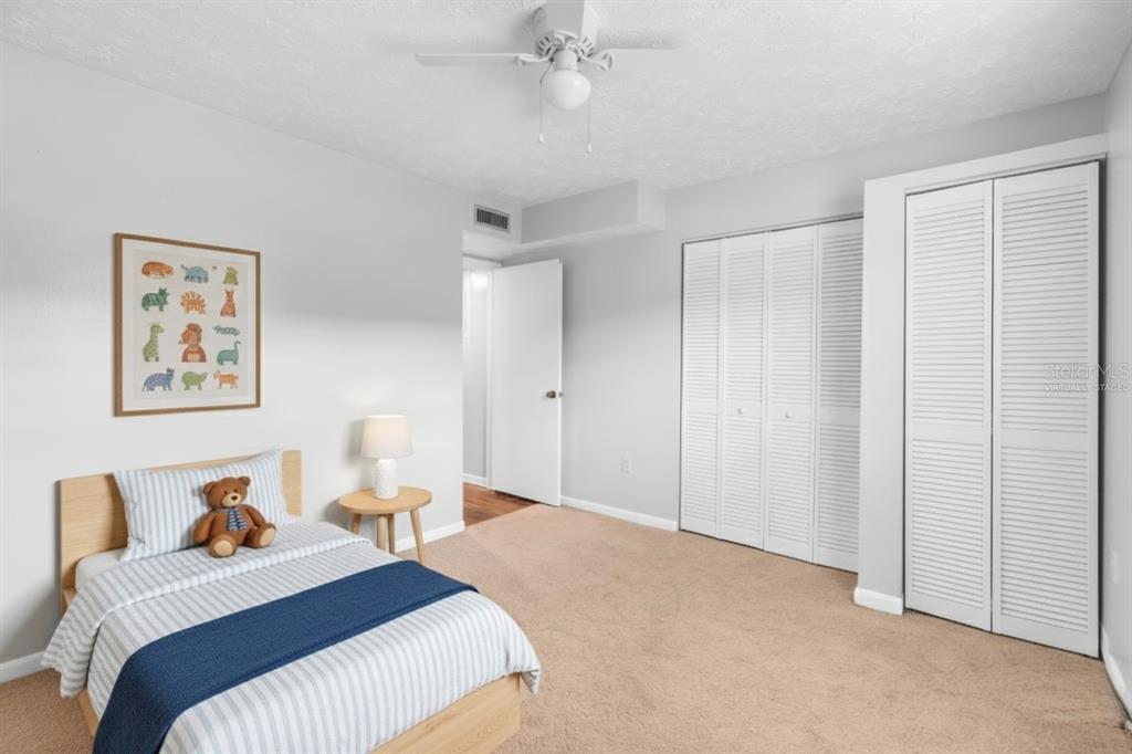 4212 Lake Underhill Road, Unit 5D9 Orlando, FL 32803 - Photo 23 of 58 a bedroom with a bed and a chandelier