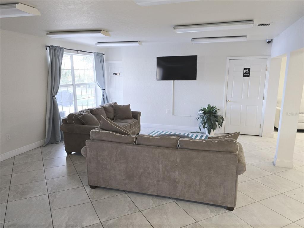 4212 Lake Underhill Road, Unit 5D9 Orlando, FL 32803 - Photo 47 of 58 a living room with furniture and a flat screen tv