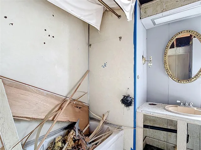 a bathroom with a sink and mirror