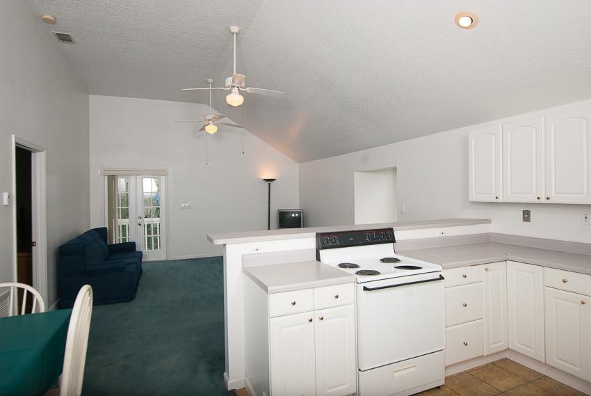 12557 154th Road North Jupiter, FL 33478 - Photo 25 of 38 a kitchen with a white cabinets stove and white cabinets