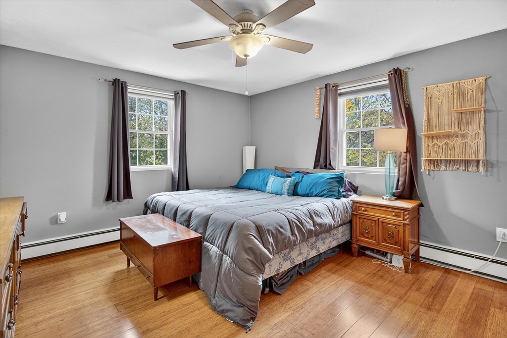 38 Bennett Street, Unit 3D Wakefield, MA 01880 - Photo 14 of 22 a bedroom with a bed and wooden floor