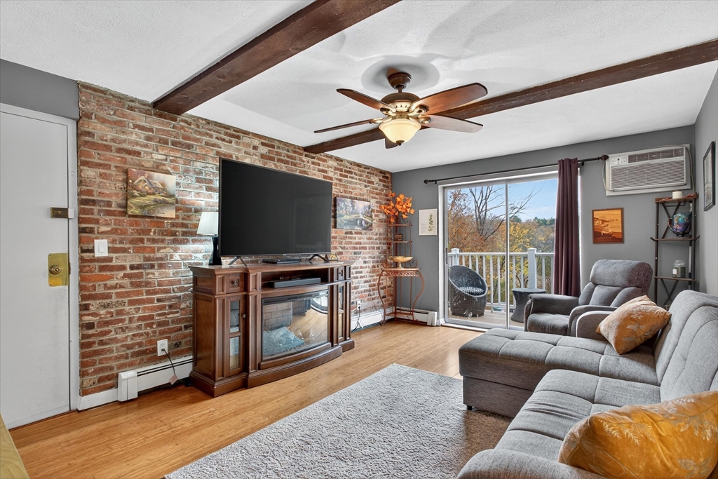 38 Bennett Street, Unit 3D Wakefield, MA 01880 - Photo 3 of 22 a living room with furniture and a flat screen tv