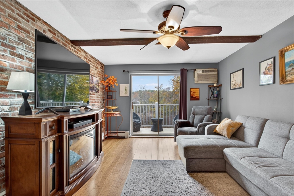 38 Bennett Street, Unit 3D Wakefield, MA 01880 - Photo 5 of 22 a living room with furniture a ceiling fan and a large window