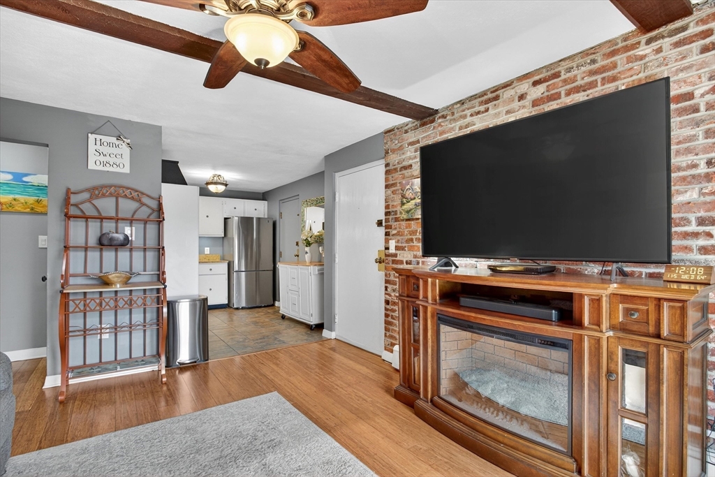 38 Bennett Street, Unit 3D Wakefield, MA 01880 - Photo 9 of 22 a living room with furniture and a flat screen tv