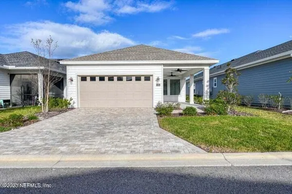 a front view of a house with a garden and plants