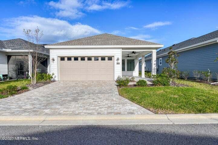 a front view of a house with a garden and plants