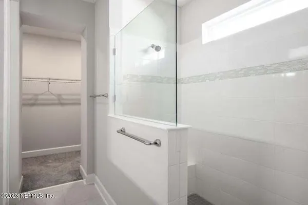a bathroom with a glass shower door