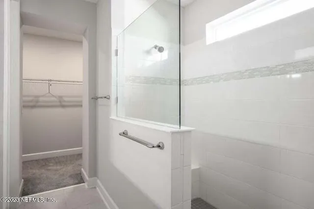 a bathroom with a glass shower door