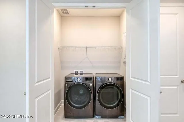 a utility room with dryer and washer