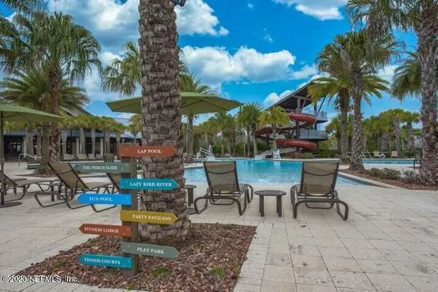a view of a patio with a table and chairs and potted plants