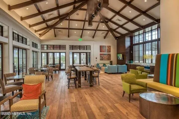 a living room with furniture a couch and a chandelier