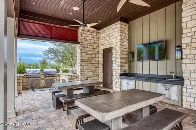 a view of a porch with furniture and a yard