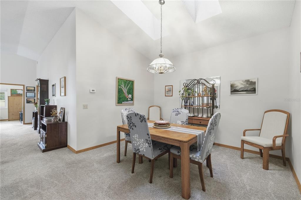 9049 Southwest 91st Circle Ocala, FL 34481 - Photo 11 of 37 a view of a dining room with furniture and chandelier