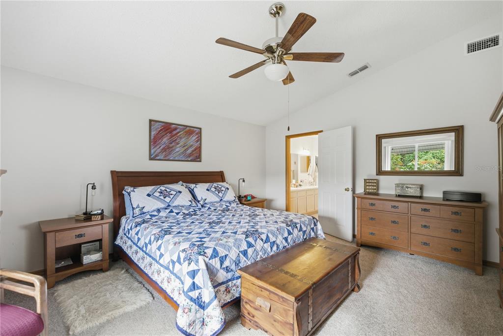 9049 Southwest 91st Circle Ocala, FL 34481 - Photo 17 of 37 a bed room with a bed and a dresser