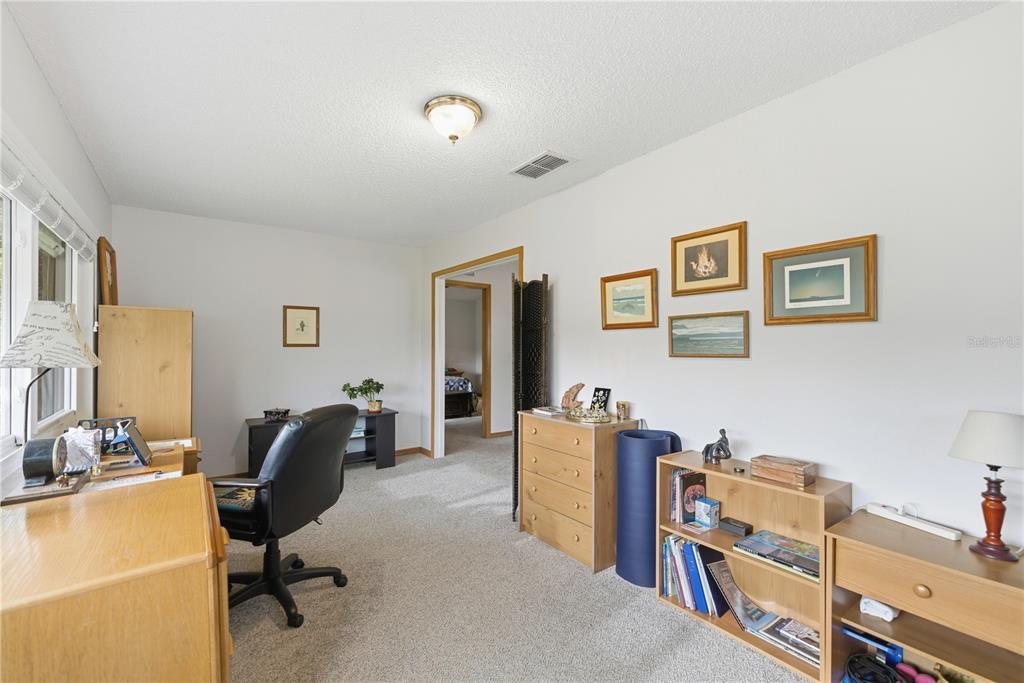 9049 Southwest 91st Circle Ocala, FL 34481 - Photo 21 of 37 a view of a workspace with furniture and a window
