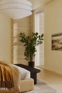 a bedroom with a bed and a potted plant