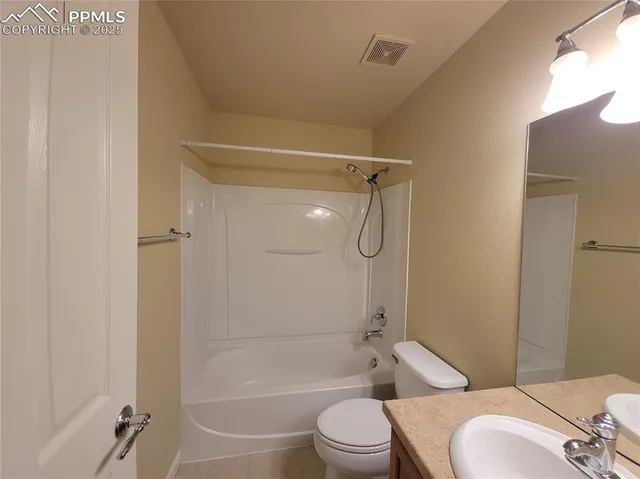 a bathroom with a toilet and shower
