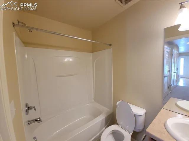 a bathroom with a toilet and a bathtub