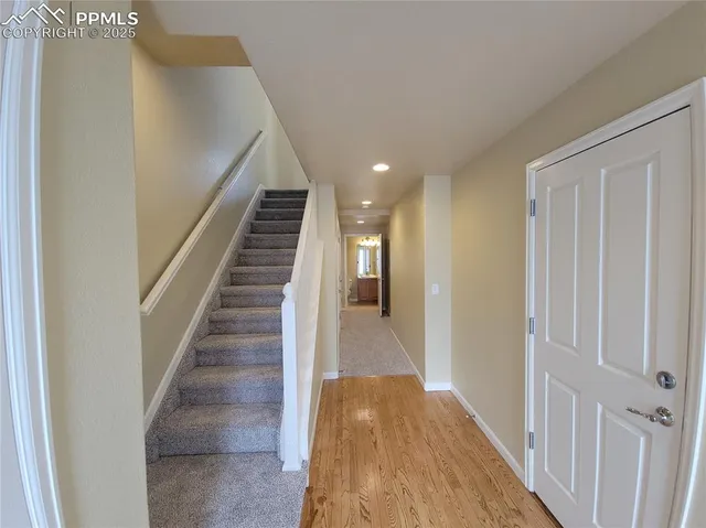 a view of entryway and hall with wooden floor