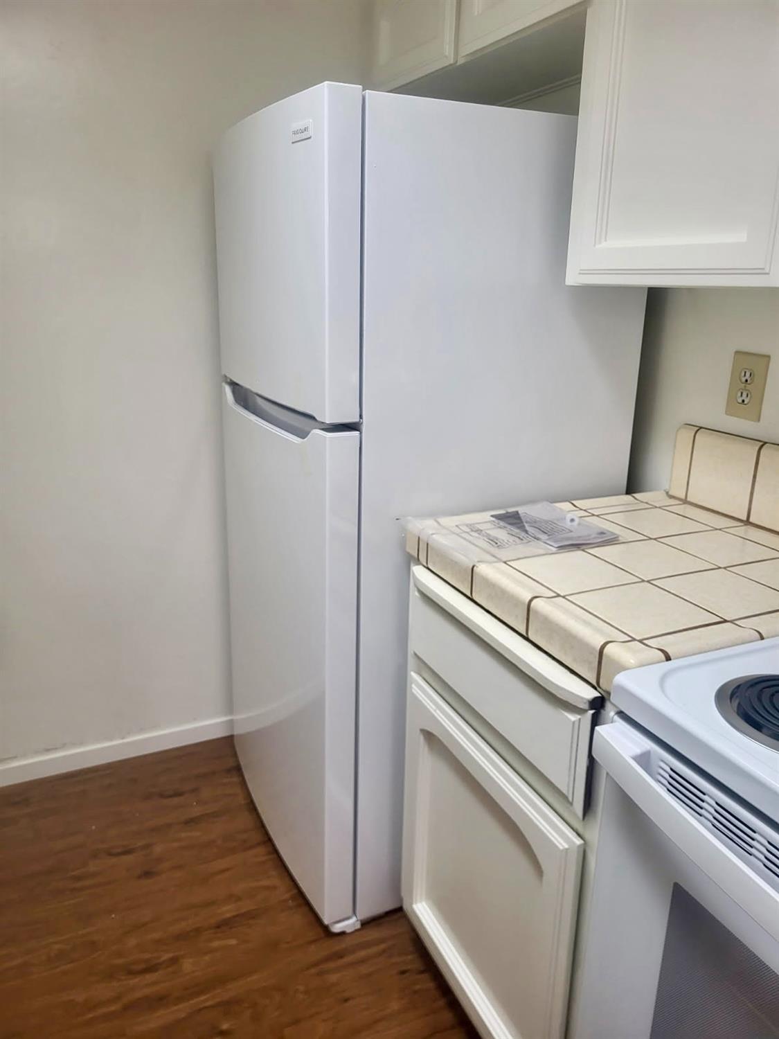 49400 River Park Road, Unit 17 Oakhurst, CA 93644 - Photo 30 of 34 a white refrigerator freezer sitting inside of a kitchen