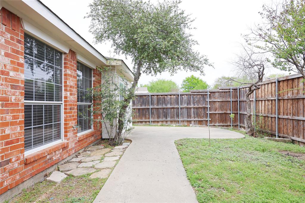 8112 Dock Street Frisco, TX 75035 - Photo 31 of 34 a view of a backyard with a small cabin and wooden fence