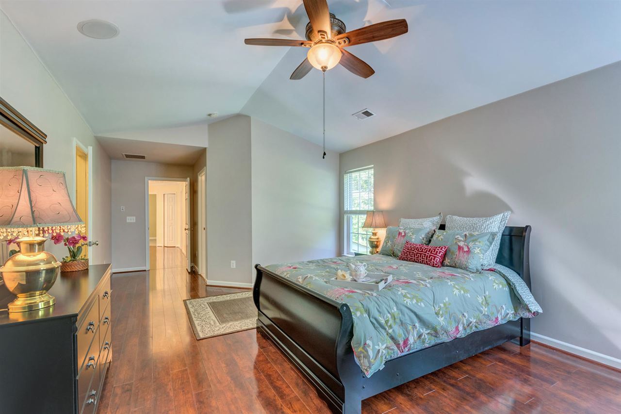 750 Reedy Creek Road Louisa, VA 23093 - Photo 23 of 41 a bedroom with a bed and wooden floor