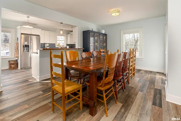 a dining room with furniture and wooden floor