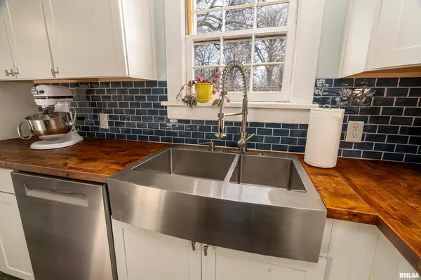 a kitchen with a sink and a stove next to a window