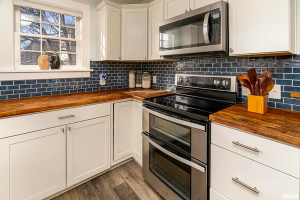 a kitchen with stainless steel appliances granite countertop a stove and a microwave