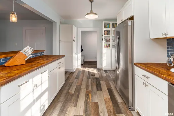 a kitchen with stainless steel appliances granite countertop a refrigerator and a stove