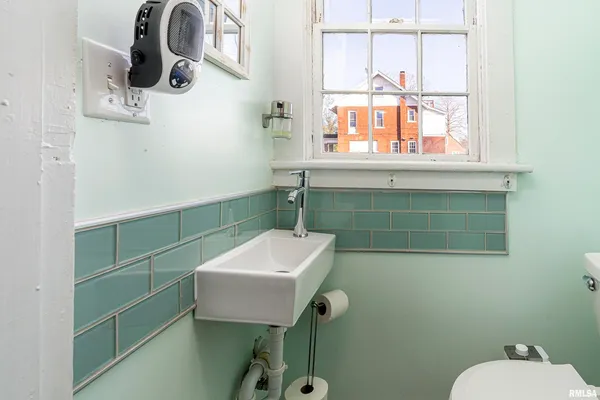 a bathroom with a sink a toilet and mirror