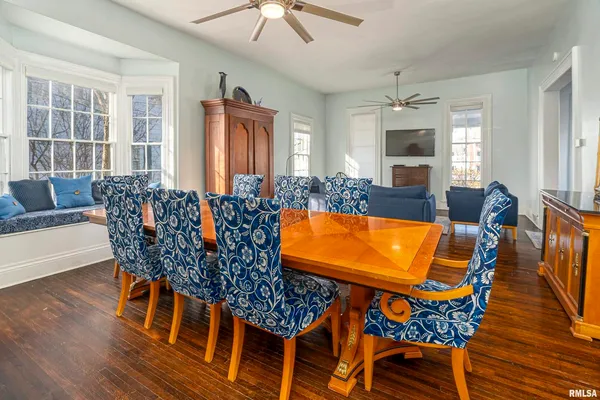 a view of a dining room with furniture window and wooden floor