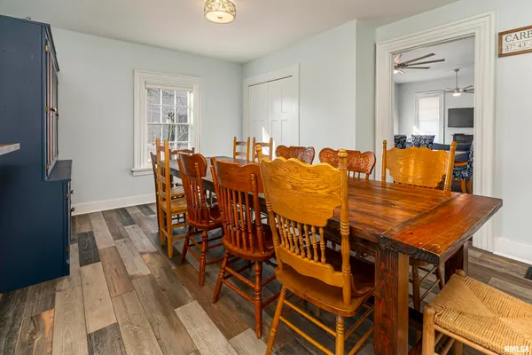 a dining room with furniture and wooden floor