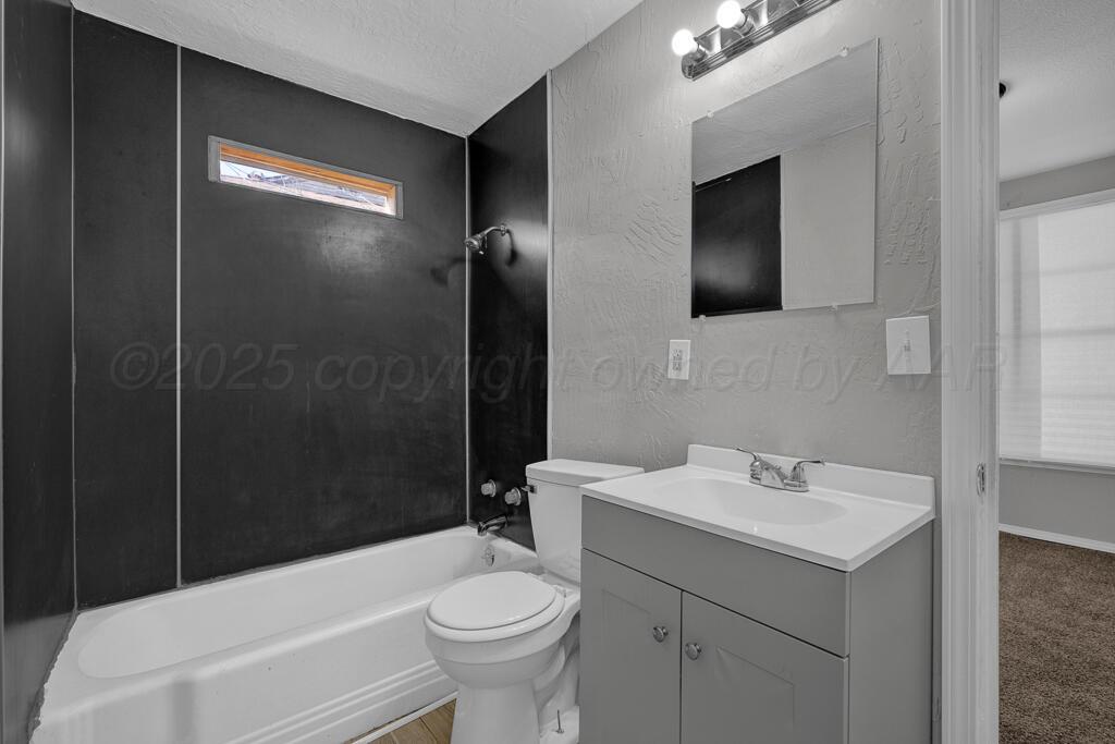 4006 Southeast 13th Avenue Amarillo, TX 79104 - Photo 11 of 16 a bathroom with a sink toilet and shower